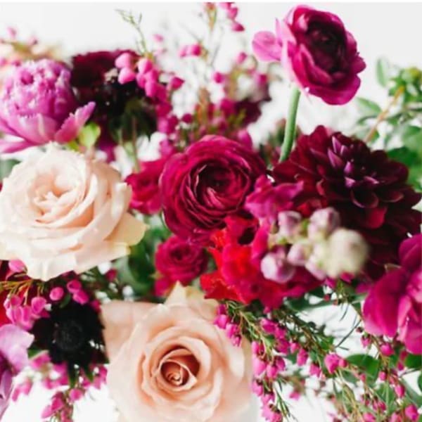 Bouquet of pink, burgundy, and cream flowers with mixed blooms