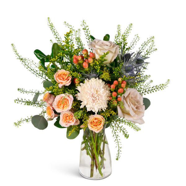 Peach and cream bouquet with roses and a white chrysanthemum in a clear glass vase