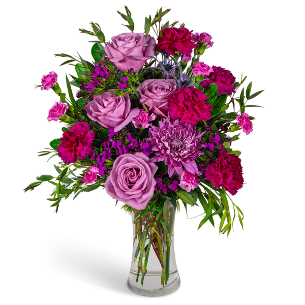 Pink roses and magenta carnations in a clear glass vase