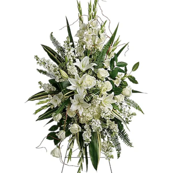 Tall white floral standing spray with lilies and roses on an easel