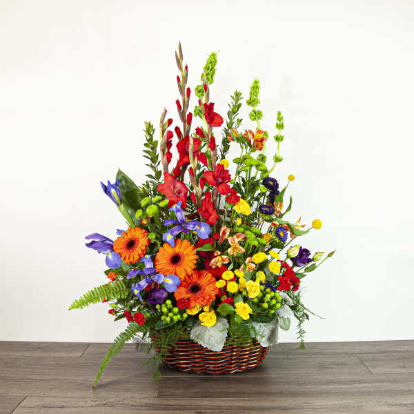 Colorful mixed flower arrangement in a woven basket