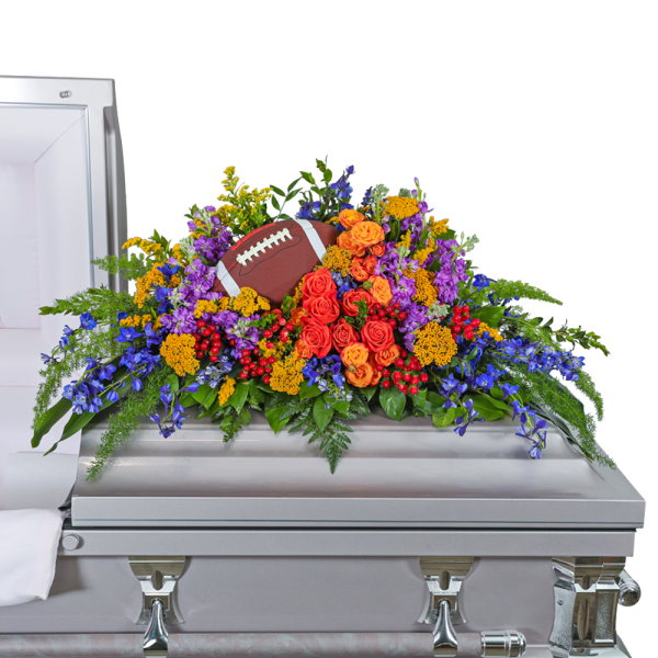 Colorful floral casket spray with a football centerpiece