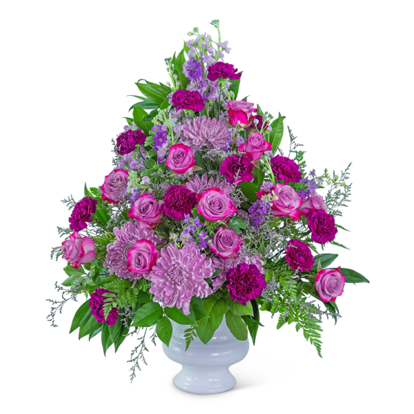 Pink and purple mixed flower arrangement in a white vase