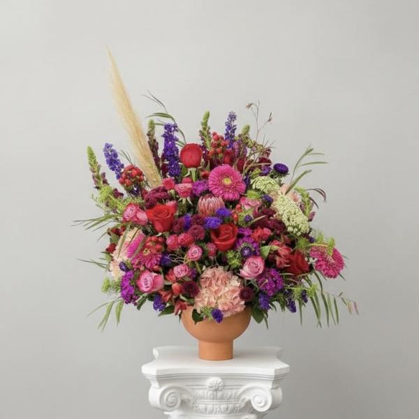 Large colorful flower arrangement in a terracotta vase