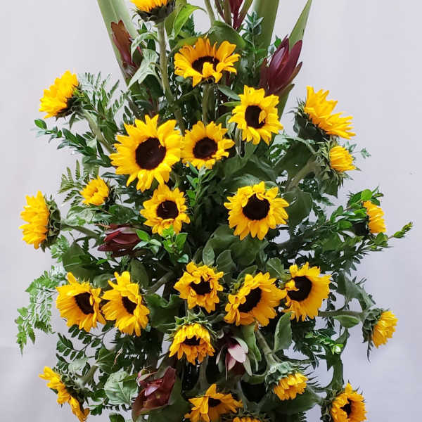 Tall sunflower arrangement with burgundy accents and greenery