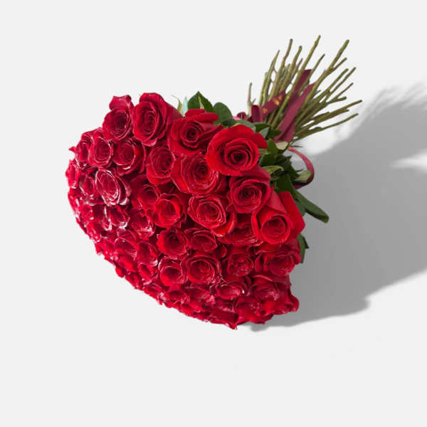 Heart-shaped bouquet of red roses with a ribbon wrap