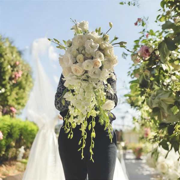 White bridal bouquet with cascading flowers and roses
