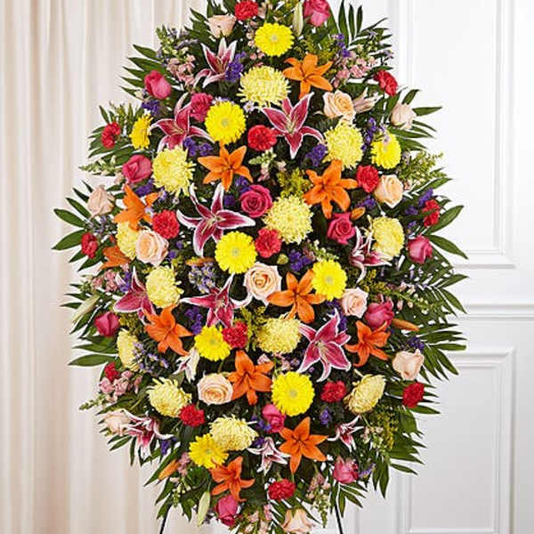 Large standing spray of mixed flowers in bright colors on an easel