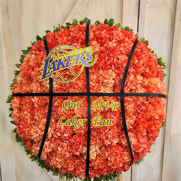 Round orange carnation tribute with a Los Angeles Lakers sign