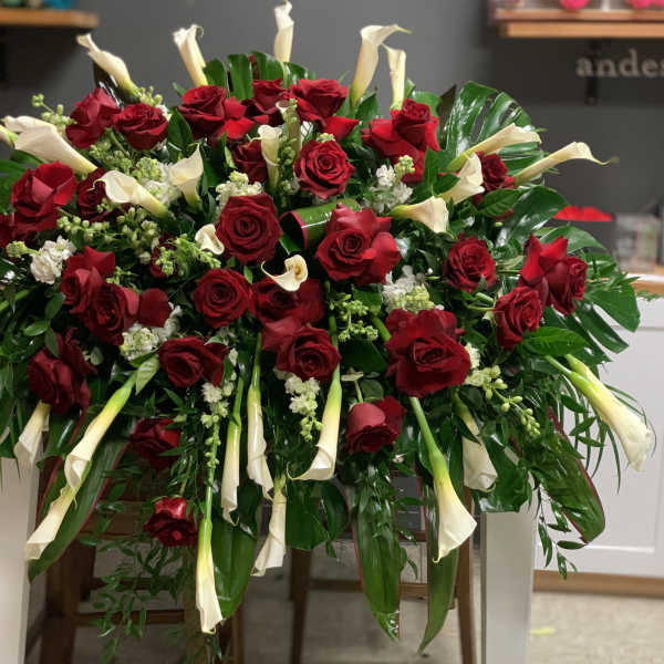 Large arrangement of red roses and white calla lilies