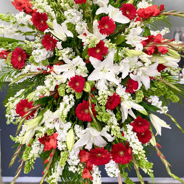 Large red and white floral spray on an easel