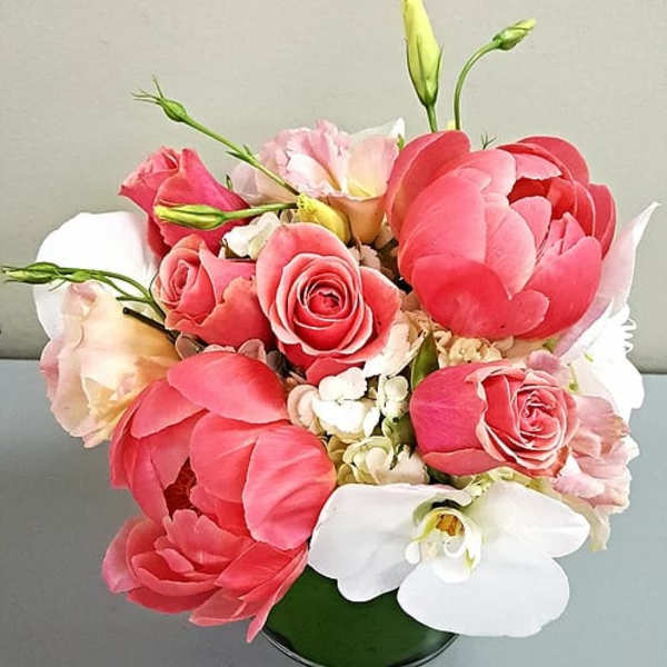 Pink and white floral bouquet in a green vase