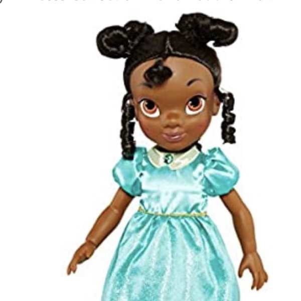 A doll wearing a turquoise dress and black shoes