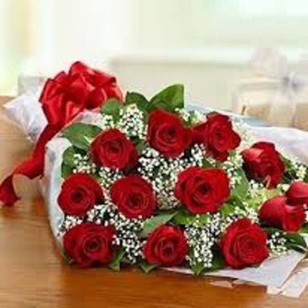Bouquet of red roses with baby's breath wrapped in white paper