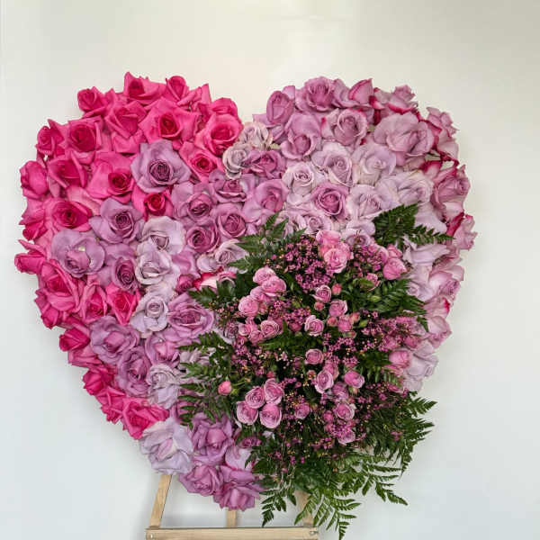 Heart-shaped pink and lavender rose arrangement on an easel