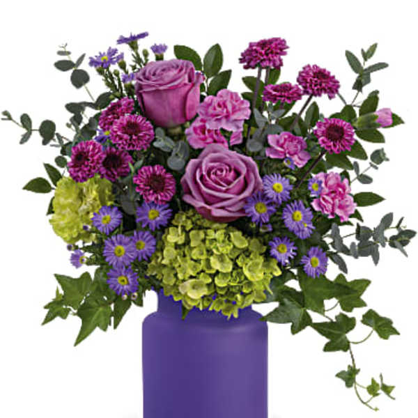 Purple and pink flower arrangement in a purple vase