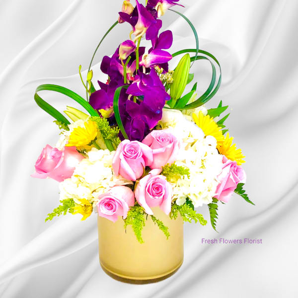 Pink roses and white flowers in a gold vase with tall purple orchids