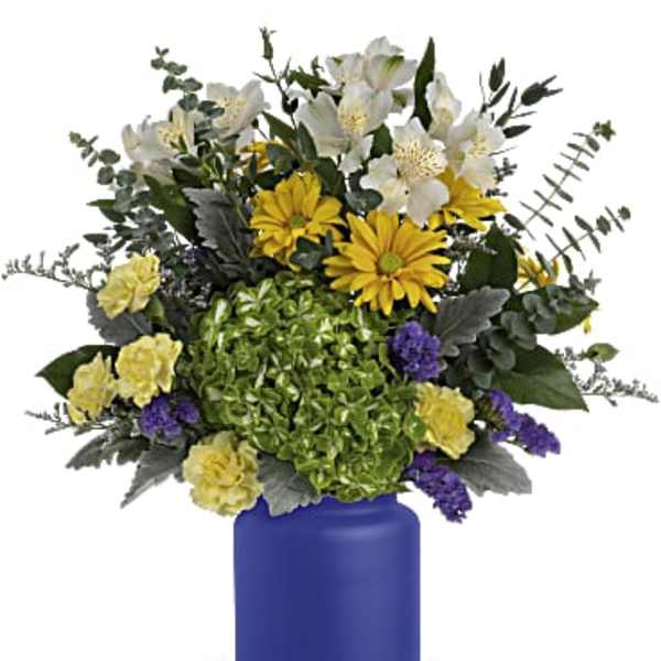 Bouquet of white, yellow, and purple flowers in a blue vase