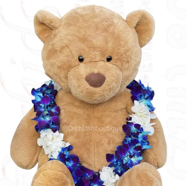 Plush teddy bear wearing a blue, purple, and white flower lei