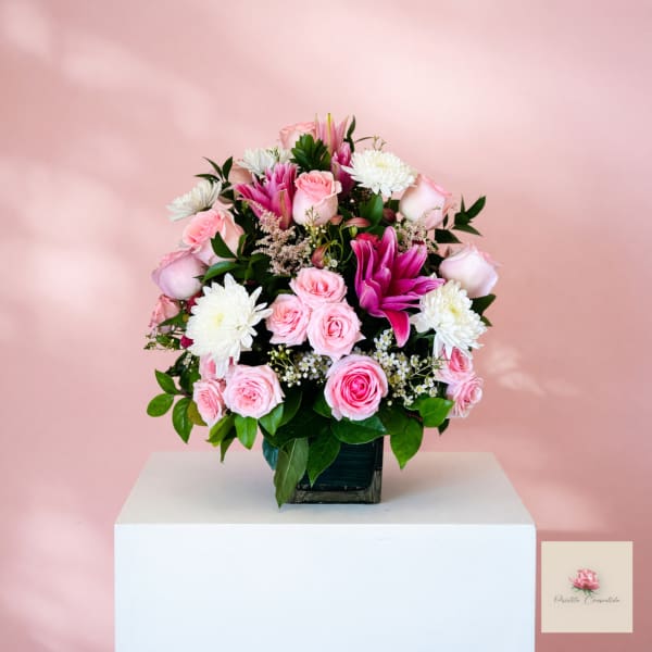 Pink and white rose bouquet with white chrysanthemums in a square vase