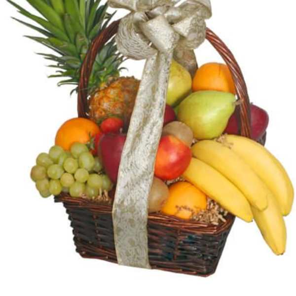 Fruit basket with bananas, grapes, oranges, and a pineapple in a wicker basket