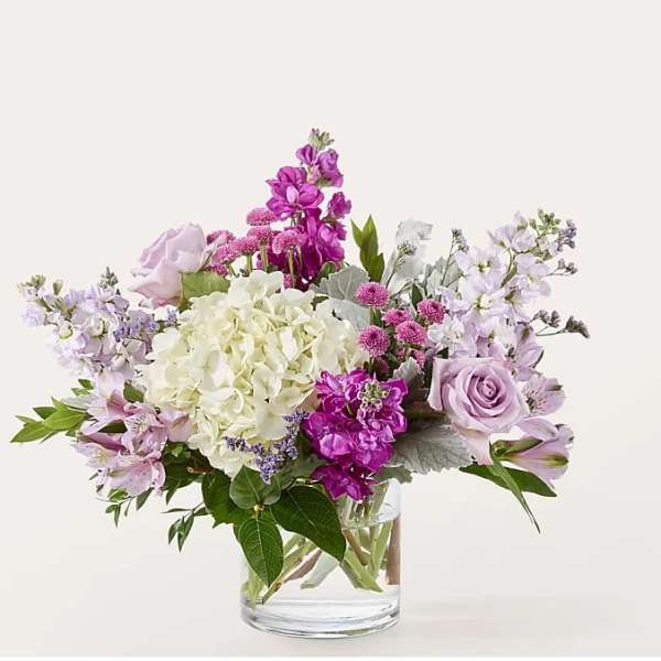 Lavender and white mixed bouquet in a clear glass vase