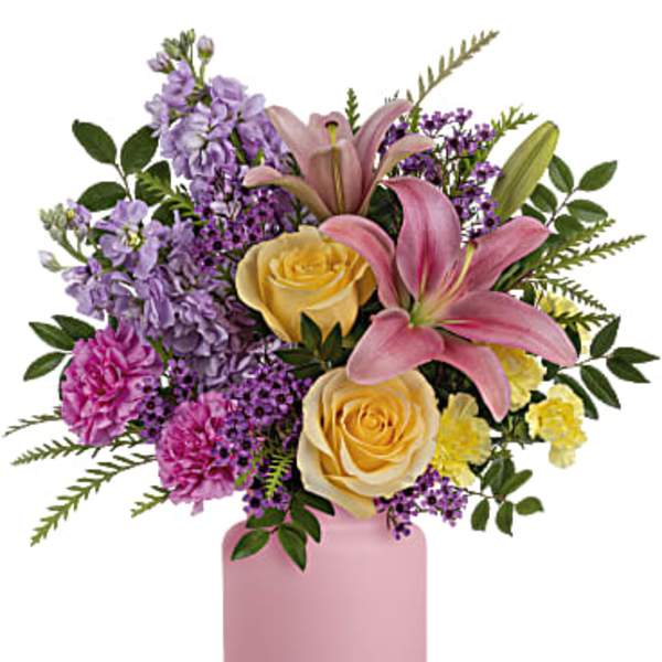Pink and yellow roses with lilies in a pink vase