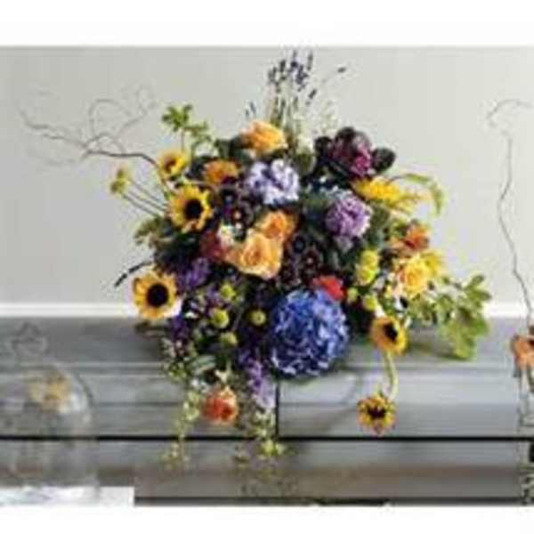 Mixed bouquet with sunflowers, purple blooms, and orange flowers