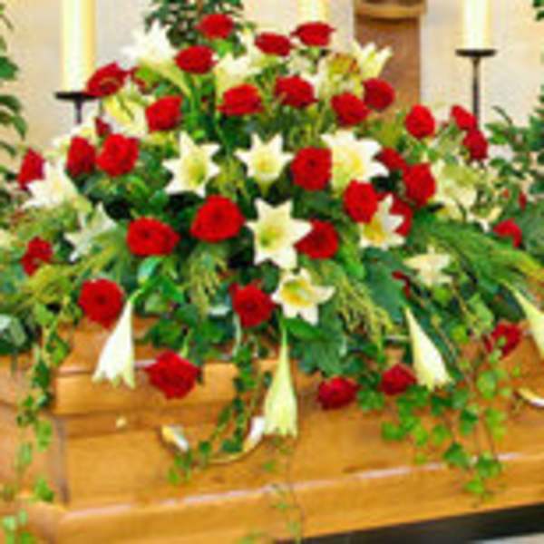 Large red and white floral casket spray with lilies and roses