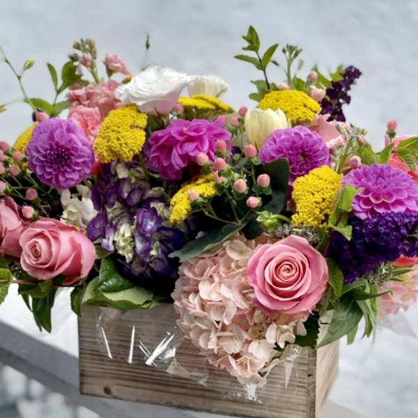 Colorful mixed flower arrangement in a wooden box