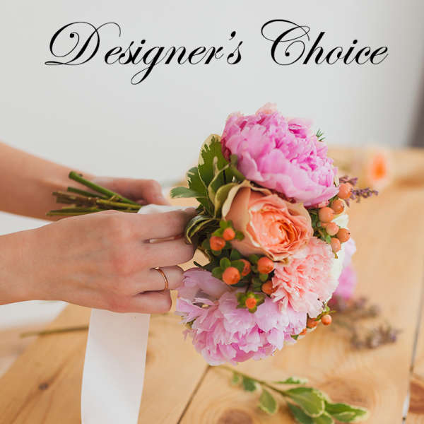 Handheld bouquet of pink peonies and peach roses with berries