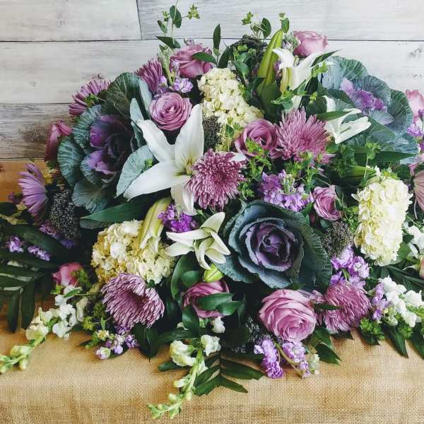Large bouquet of pink, purple, and white flowers with greenery