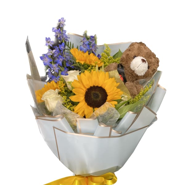 Bouquet of sunflowers, blue flowers, white roses, and a teddy bear