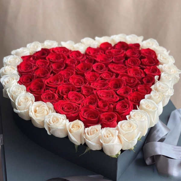 Heart-shaped box filled with red and white roses