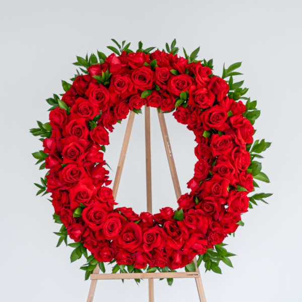 Red rose wreath on a wooden easel