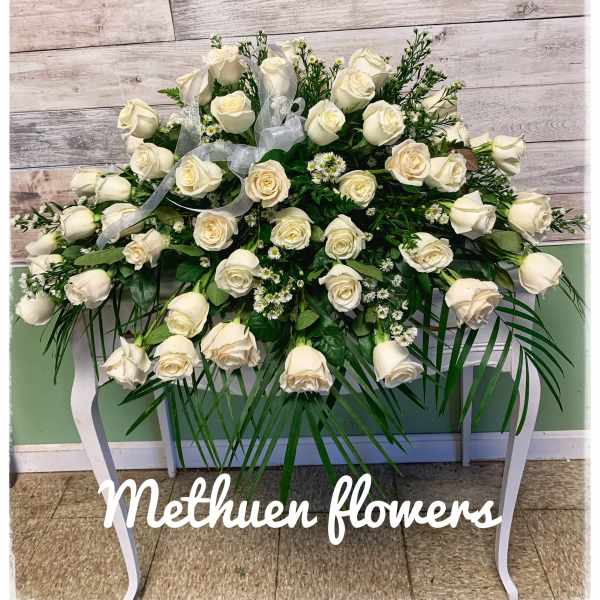 Large white rose spray on a stand with ribbon