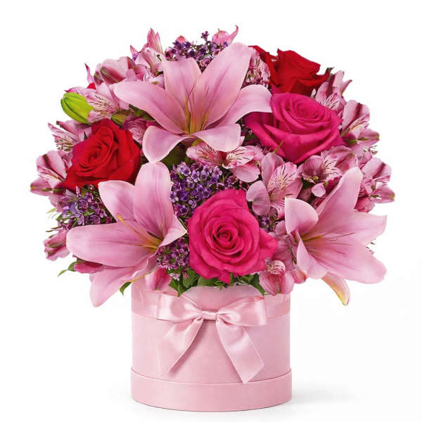 Pink and red bouquet with lilies and roses in a pink hatbox