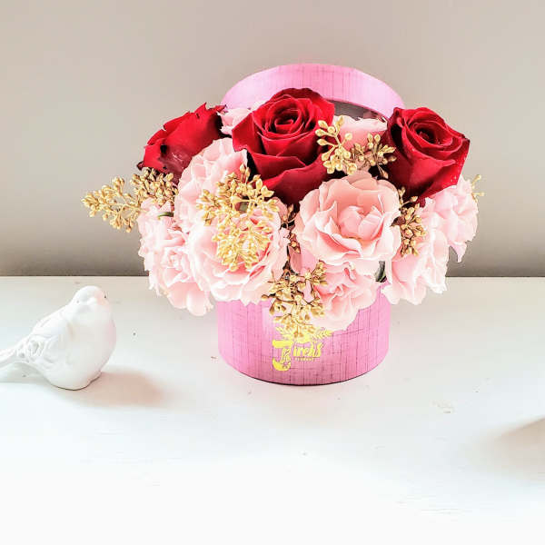 Pink and red rose arrangement in a pink hat box
