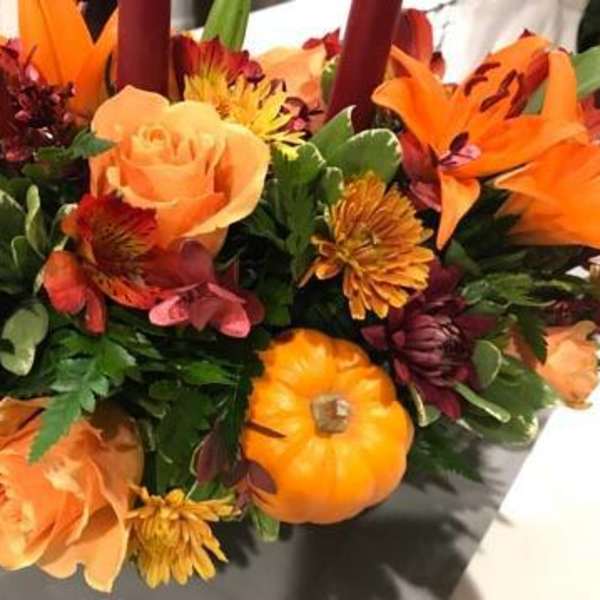 Autumn bouquet with orange roses, lilies, and chrysanthemums