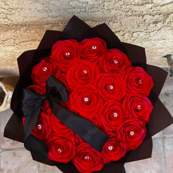 Bouquet of red roses wrapped in black paper with a black ribbon