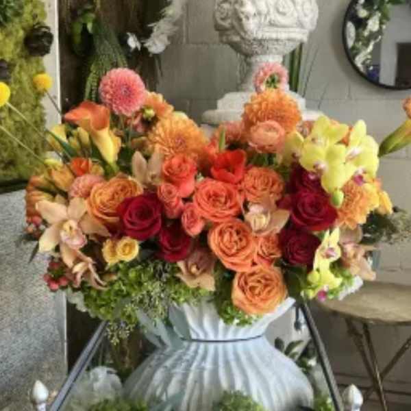Colorful mixed flower arrangement in a white vase