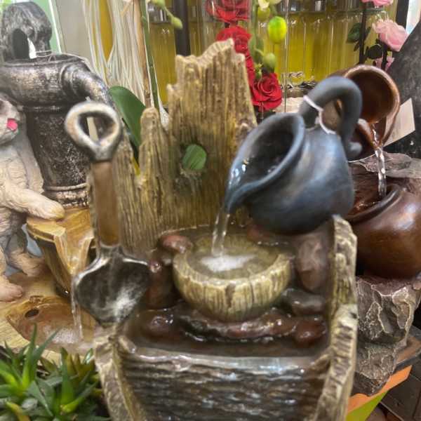 Decorative tabletop water fountain with ceramic pitchers and bowls
