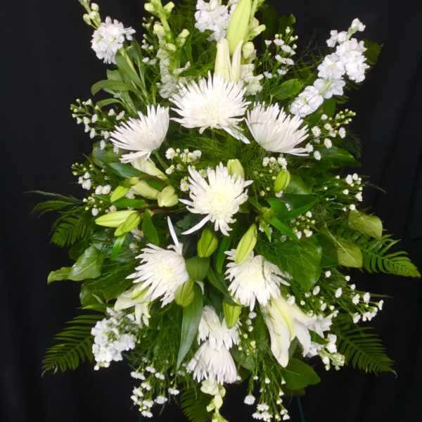 White floral standing spray with lilies and spider mums