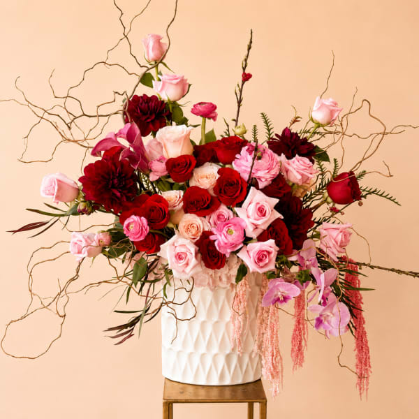 Large bouquet of pink and red roses in a white vase