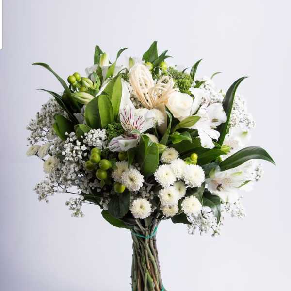 White and green bouquet with mixed blooms and long stems tied together