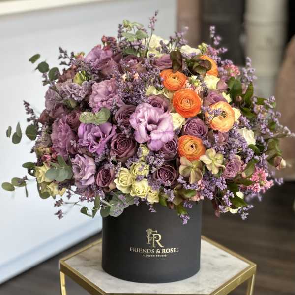 Lavender and orange mixed bouquet in a black hat box