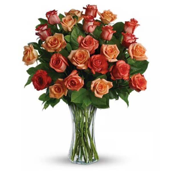 Bouquet of peach and red roses in a clear glass vase