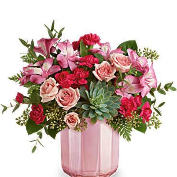 Pink and red mixed bouquet in a pink glass vase