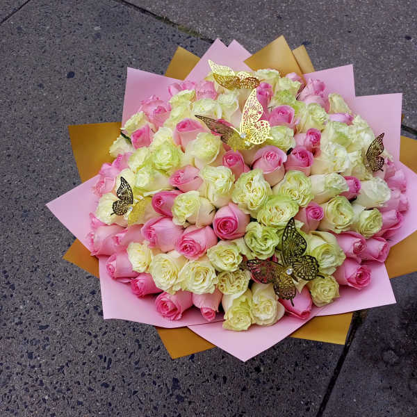 Large bouquet of pink and cream roses with butterfly picks