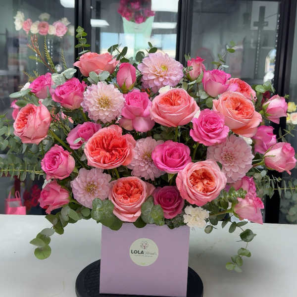 Pink and peach rose bouquet in a lavender box